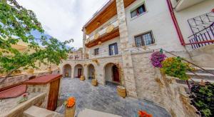 a building with a courtyard with flowers on it at Black Stove Cappadocia in Ortahisar