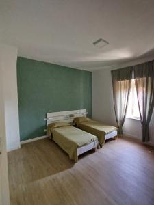 Postel nebo postele na pokoji v ubytování Residenza Cimone