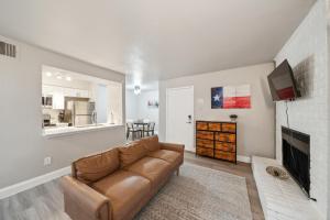 a living room with a couch and a fireplace at The Chandler 412 I Spacious 1 Bed 1 Bath in Grand Prairie
