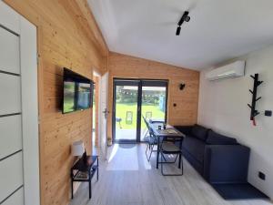a living room with a couch and a table at W dolinie Rocha in Krasnobród