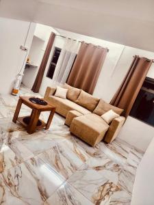 a living room with a couch and a table at Snz Guesthouse in Port Louis