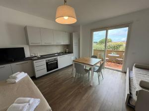a kitchen and dining room with a table and chairs at Residence San Francesco in Tirrenia