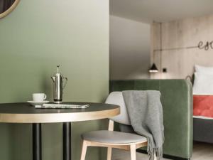 a table and a chair next to a bed at Hotel Norge by Scandic in Bergen +37 photos