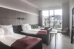 a hotel room with two beds and a window at Hotel Norge by Scandic in Bergen