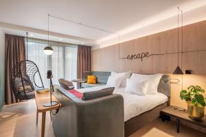 a hotel room with a bed and a chair at Hotel Norge by Scandic in Bergen