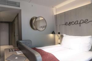 a bedroom with a bed with a mirror on the wall at Hotel Norge by Scandic in Bergen
