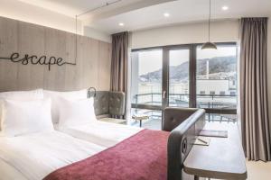 a hotel room with a bed and a table at Hotel Norge by Scandic in Bergen