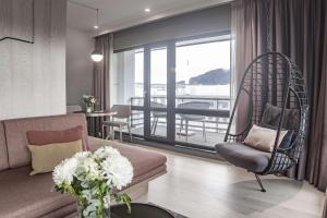 a living room with a chair and a swing at Hotel Norge by Scandic in Bergen