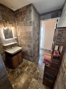 a stone bathroom with a sink and a staircase at Watervillas Breezy Bay in Kralendijk +29 photos