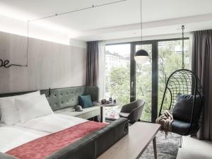 a hotel room with a bed and a chair at Hotel Norge by Scandic in Bergen
