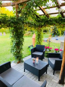 a patio with chairs and a table and a pergola at Noclegi u Justyny in Łagów +3 photos