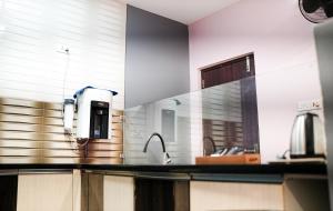 a kitchen counter with a sink and aounterpectrophe at H2cottage in Wodapatti