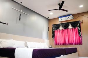 a bedroom with two beds and a window at H2cottage in Wodapatti