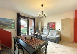 a living room with a table and a couch at Dream Villa in Stresa in Stresa