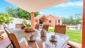 a table with a bowl of fruit on a patio at Los Caracoles de Almogía by Ruralidays in Almogía