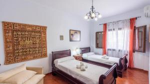 a living room with two beds and a couch at Los Caracoles de Almogía by Ruralidays in Almogía +33 photos