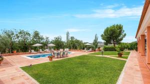 a backyard with a swimming pool and a lawn at Los Caracoles de Almogía by Ruralidays in Almogía