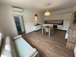 a living room and kitchen with a couch and a table at Residence San Francesco in Tirrenia