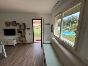 a living room with a couch and a large window at Residence San Francesco in Tirrenia