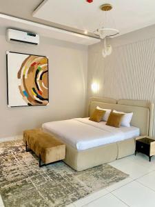 a bedroom with a bed and a painting on the wall at Home away from home in Lagos
