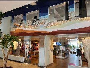 a store with mannequins on display in a mall at Hot Beach Suites in Olímpia