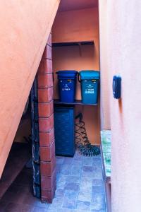 a room with two blue buckets on a shelf at "La casa di Ryan" - Camere -Tra Cagliari e il Mare in Monserrato
