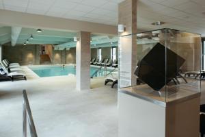 vestíbulo con piscina y TV en una vitrina en Hotel Termal - Terme 3000 - Sava Hotels & Resorts, en Moravske Toplice