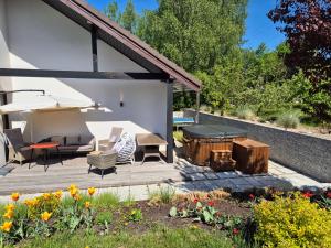 a backyard patio with a table and a grill at Siedlisko nad Drwęcą z jacuzzi i siłownią in Krobia
