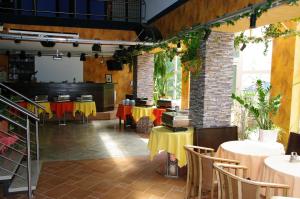 a restaurant with tables and chairs in a room at Landhotel Goldener Löwe mit Pension Am Taurastein in Burgstaedt