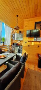 a living room with a couch and a table and a kitchen at Бунгало Шангри Ла-3, плаж Градина in Sozopol