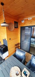 a room with a table and a couch in a cabin at Бунгало Шангри Ла-3, плаж Градина in Sozopol