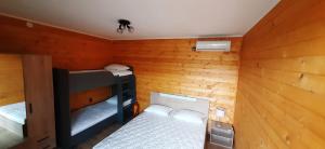 a small room with two bunk beds in it at Бунгало Шангри Ла-3, плаж Градина in Sozopol +30 photos