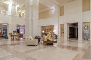 a large lobby with couches and chairs in a building at Pestana Bahia Praia Nature & Beach Resort in Vila Franca do Campo