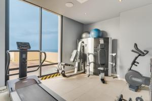 a gym with treadmills and machines in a room at Pestana Bahia Praia Nature & Beach Resort in Vila Franca do Campo