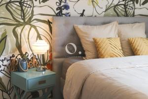 a bedroom with a bed and a table with a lamp at GC - Au Vent Du Kent in Wissant