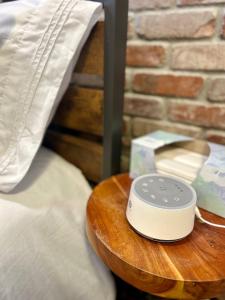 a remote control sitting on a table next to a bed at Eagle's Landing - Logan Airport in Boston