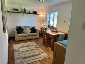 a living room with a couch and a table at 13 St Mary's Mews in Mold