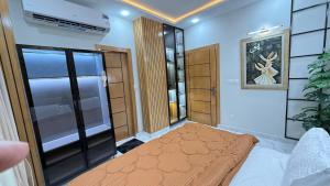 a bedroom with a bed in a room at ParkView City Lake Facing in Malot +2 photos