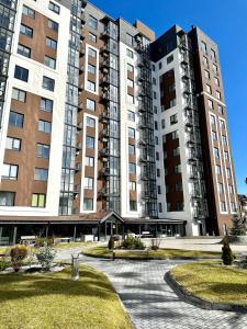 a large building with two tall buildings at Stylish apartments in the city center in Rivne +9 photos