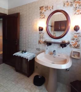 a bathroom with a sink and a mirror at VILLA Amena WI-FI AC Giardino privato in SantʼAntonio +9 photos