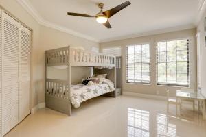 a bedroom with a bunk bed and a ceiling fan at Spacious and Modern Apt with Spa Access in Wellington! in Wellington +28 photos