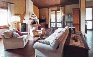 a living room with two couches and a fireplace at VILLA Amena WI-FI AC Giardino privato in SantʼAntonio