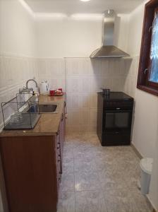 a small kitchen with a sink and a stove at Apartment Marchela in Nesebar +4 photos