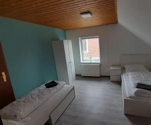 a room with two beds and a window at Team Unterkunft bei Büttel in Sankt Margarethen
