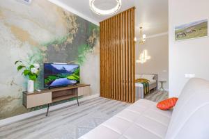 a living room with a couch and a tv at Mechta in Astana