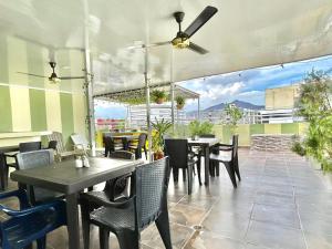a restaurant with tables and chairs on a patio at Hotel Brisas Del Mar Suite in Santa Marta +23 photos