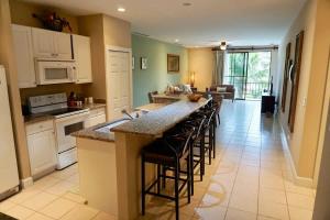 a kitchen with a large island with bar stools at Luxurious Pacifico 2bed condo in Playa Coco in Coco