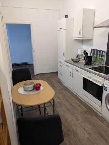 a kitchen with a table with a bowl of fruit on it at 3 Zimmer Loftwohnung in Itzehoe in Itzehoe +14 photos