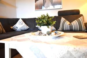 a living room with a table and a couch at FeWo Sol Mare Whg2 in Kellenhusen