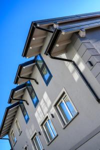 a tall building with windows on the side of it at Bilocale Vitruviano Treviglio Milano Upper Stay in Treviglio +4 photos